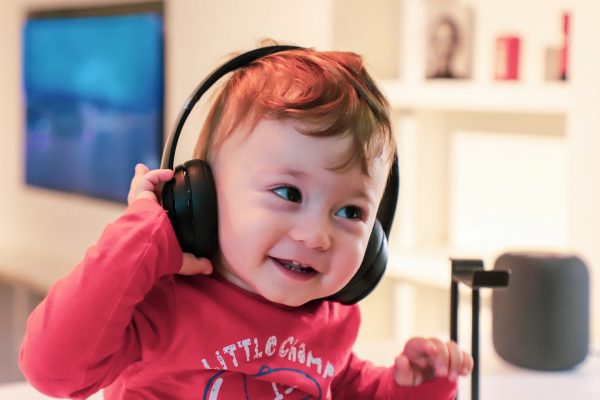 Child listens to music on headphones